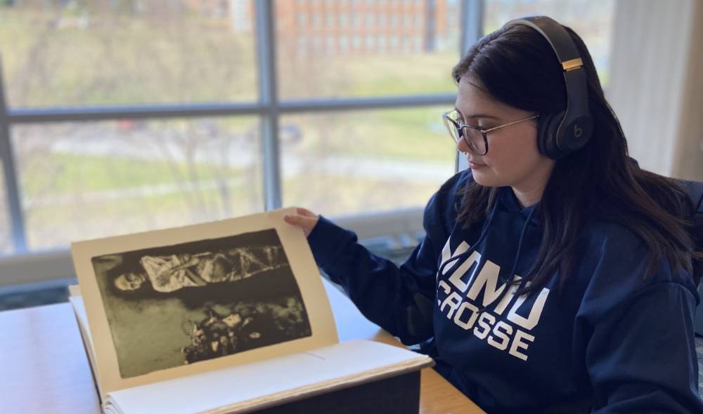 Student reading a book in Archives reading room